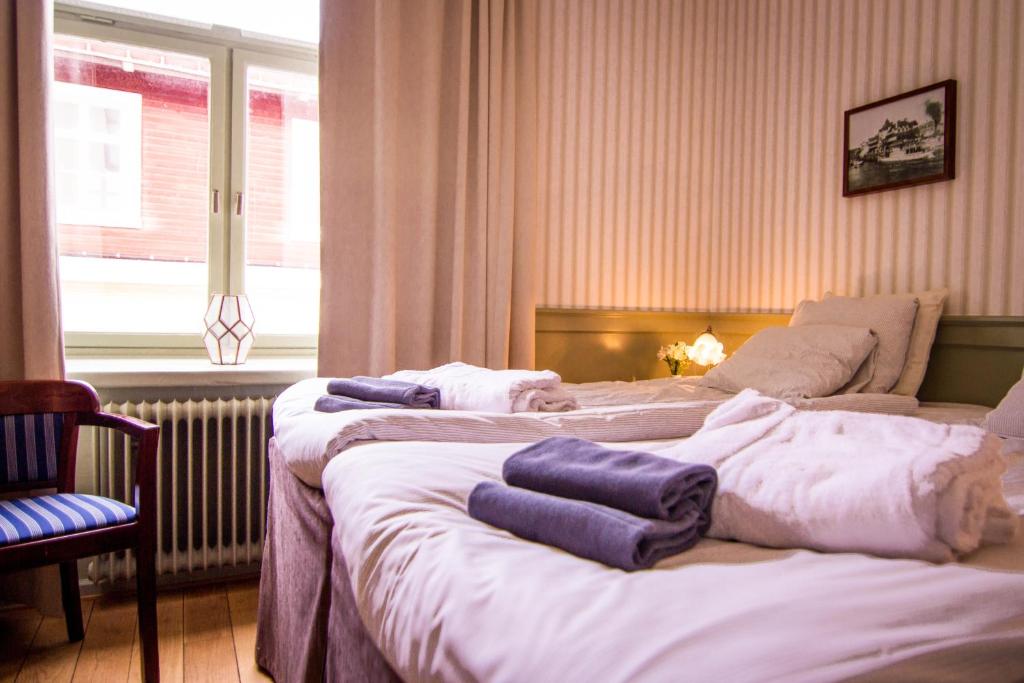 Postel nebo postele na pokoji v ubytování Waxholms Hotell