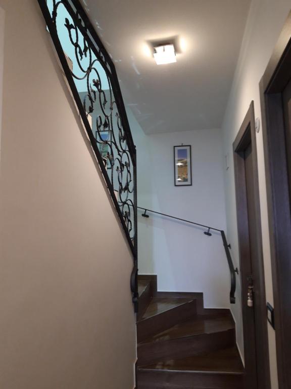a stairway with a wrought iron railing and a stair case at Valeri 's Country House in Sperlonga