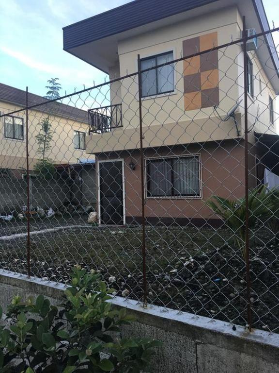 a chain link fence in front of a house at Pines Mansion II in Butuan