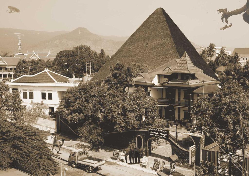 a black and white photo of a house with a pyramid at The Magic Sponge in Kampot