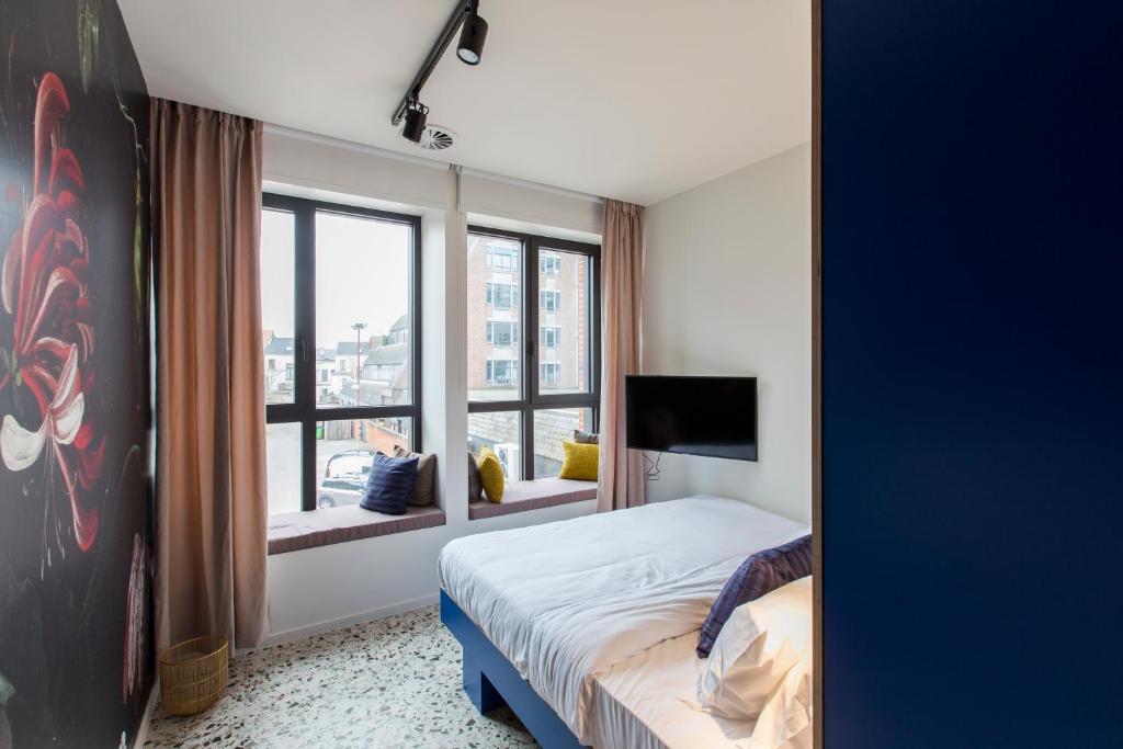 Uma cama ou camas num quarto em YUST Antwerp