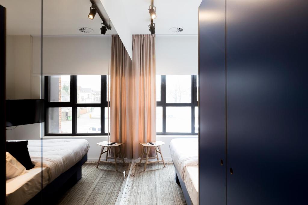 Uma cama ou camas num quarto em YUST Antwerp