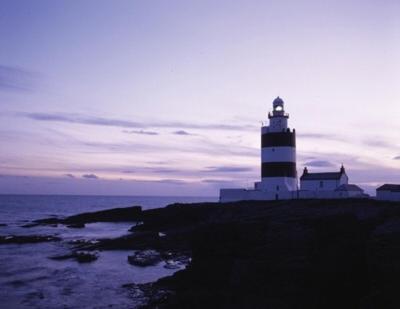 a lighthouse sitting on the edge of a cliff at Glenhill B&B in Wexford