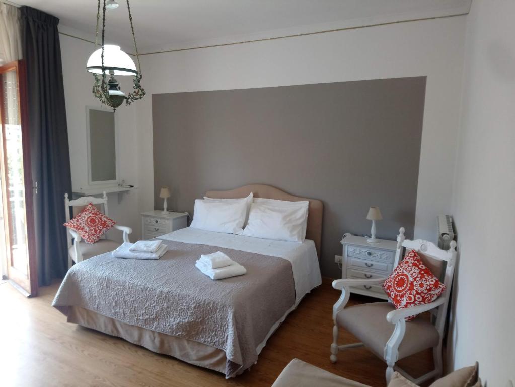 - une chambre avec un lit et deux chaises dans l'établissement B&B Casa Vienna, à Sant'Agnello