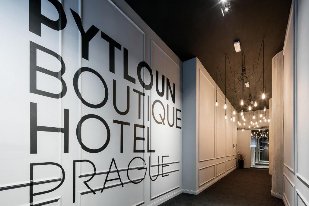 a hallway with a large black and white wall at Pytloun Boutique Hotel Prague in Prague