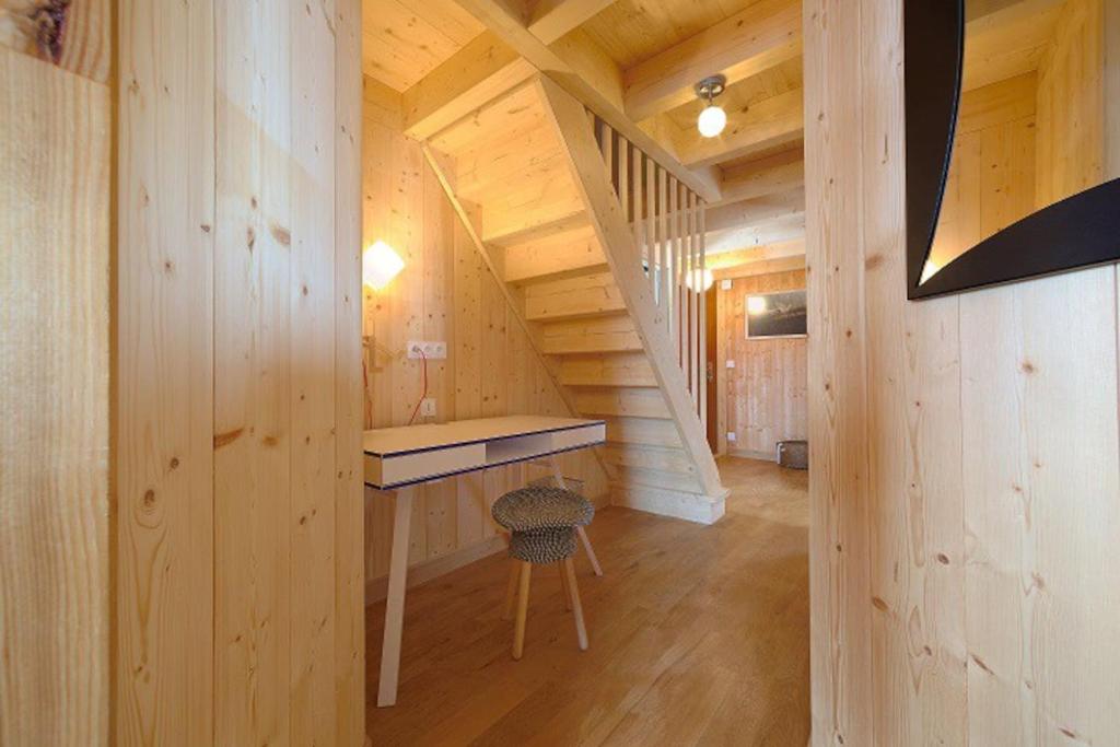 a log cabin with a desk in the middle of a room at Gîte du Bief de la Chaille in Les Rousses