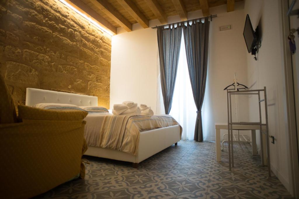 a bedroom with a bed and a large window at B&B Kolymbetra in Agrigento