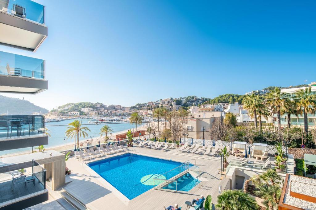 an apartment with a swimming pool and a view of the water at Hotel Eden Soller in Port de Soller