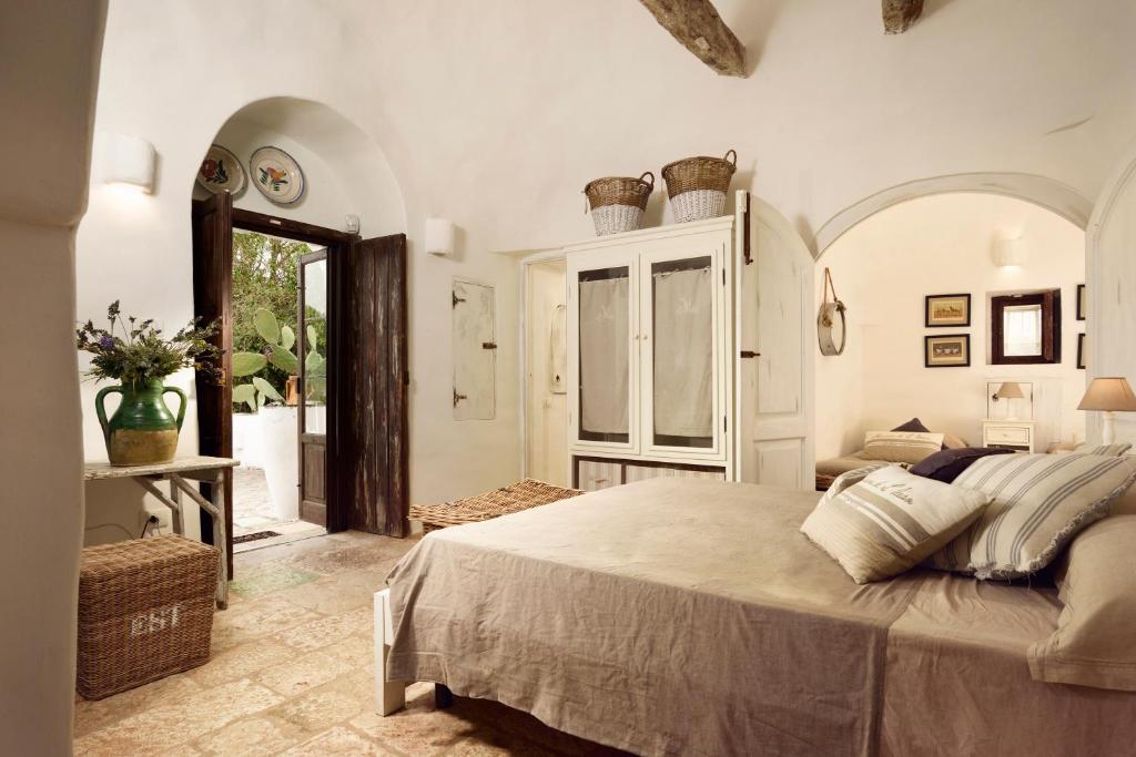 Postel nebo postele na pokoji v ubytování B&B Trullo Barbagiullo