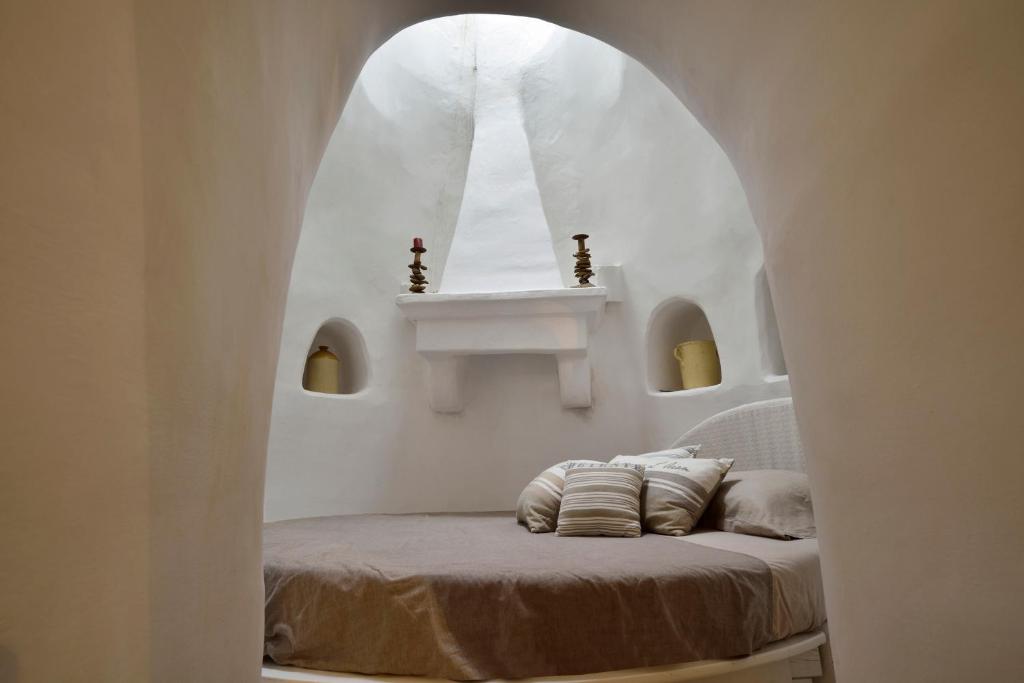 Postel nebo postele na pokoji v ubytování B&B Trullo Barbagiullo