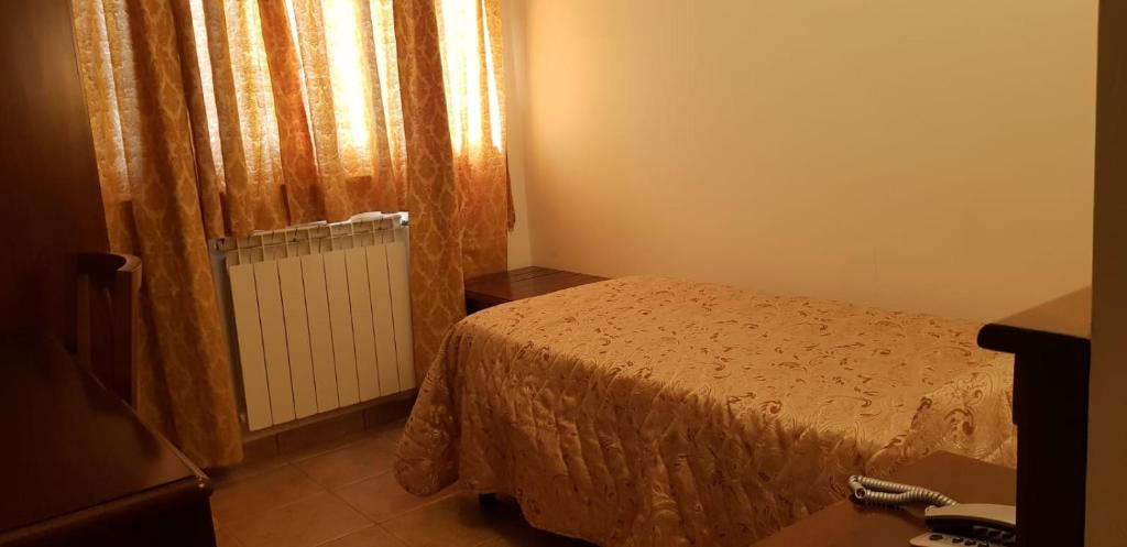 Postel nebo postele na pokoji v ubytování Hotel Vitalba