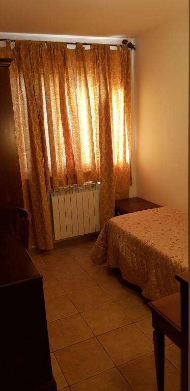 Postel nebo postele na pokoji v ubytování Hotel Vitalba