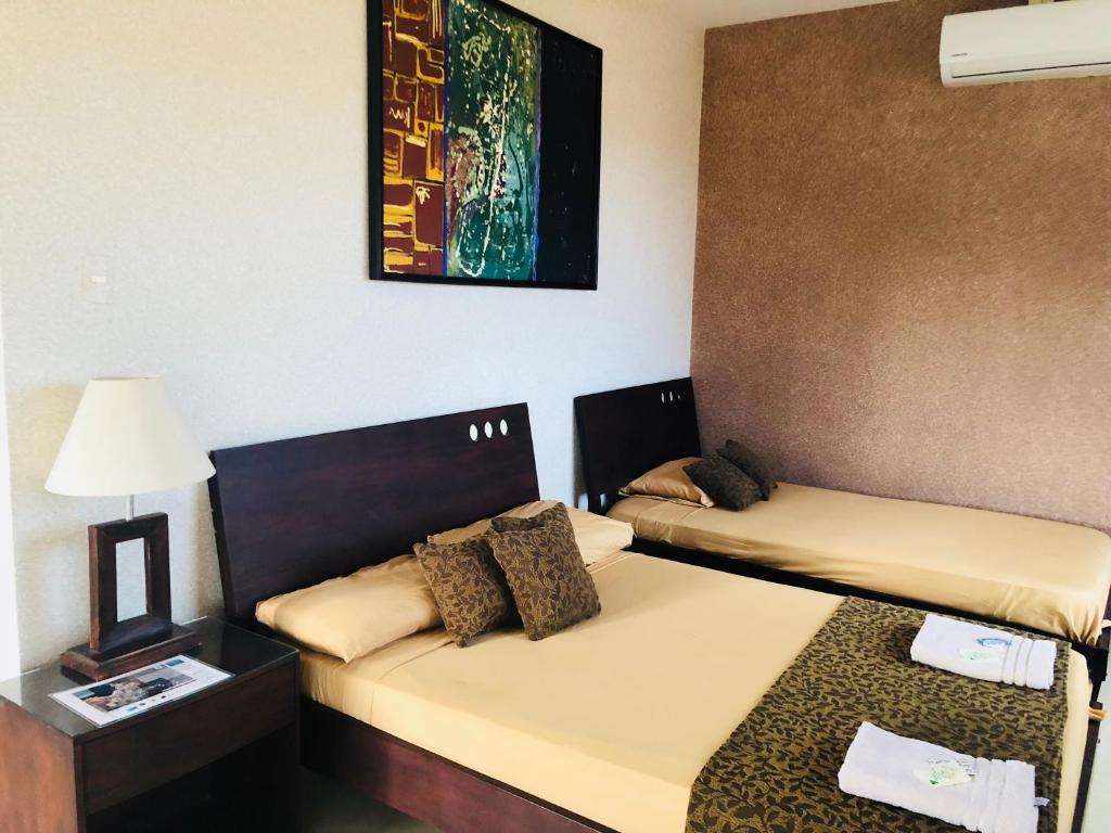 Postel nebo postele na pokoji v ubytování Eco Hotel Katarma