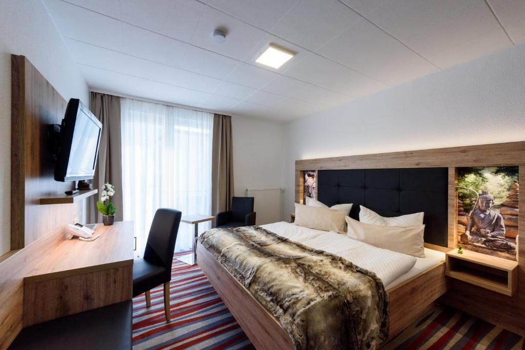 Postel nebo postele na pokoji v ubytování Wellness & Ayurveda Hotel Am Eichenberg