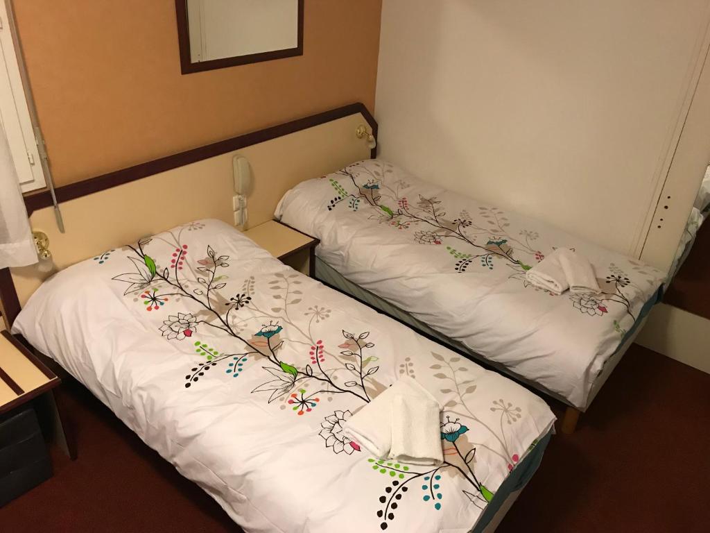 Postel nebo postele na pokoji v ubytování Hôtel Myosotis