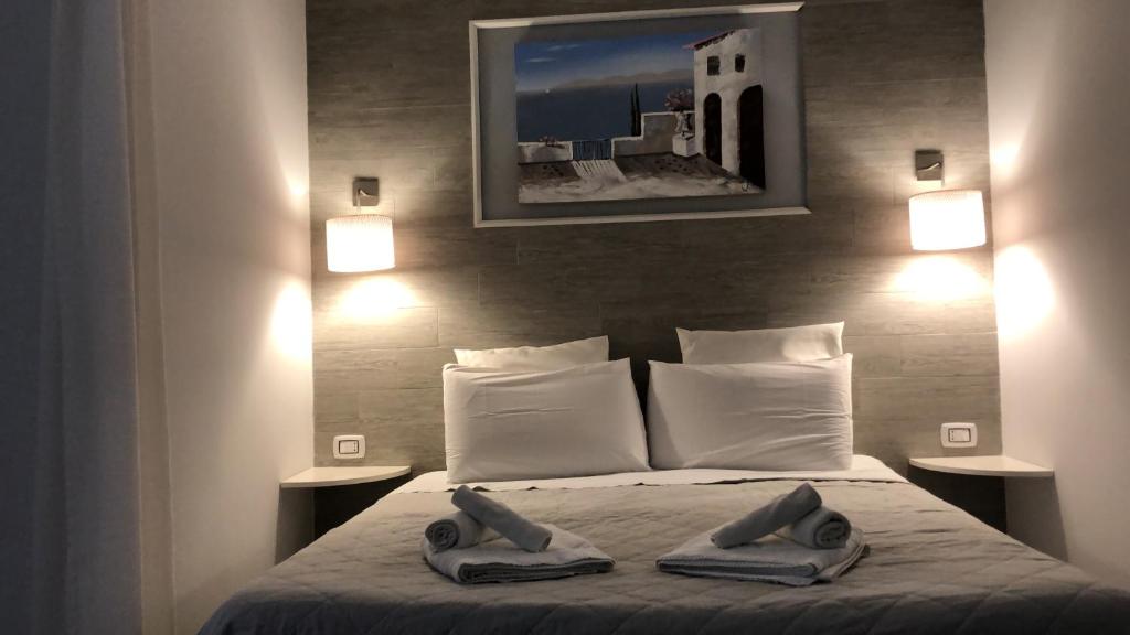 a bedroom with a bed with two towels on it at Al Bastione Holiday House in Palermo