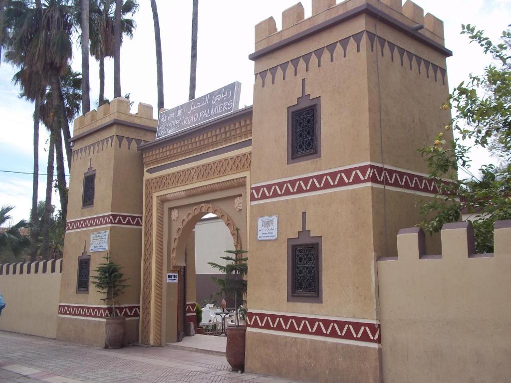 a gate to a building with a sign on it at Riad Taroudant Palmiers in Taroudant
