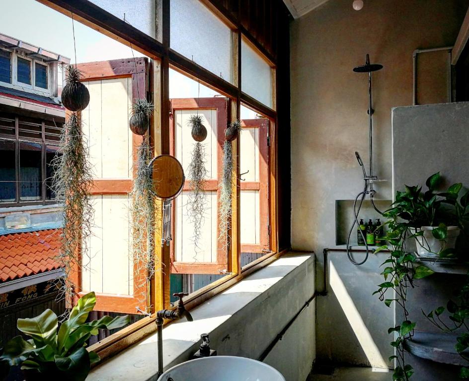 a bathroom with a window with plants and a sink at LEJU 8 樂居 Loft living with open air bathroom in Melaka