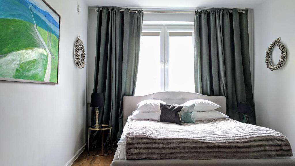 a bedroom with a bed and a window at VanGogh by mythings in Warsaw
