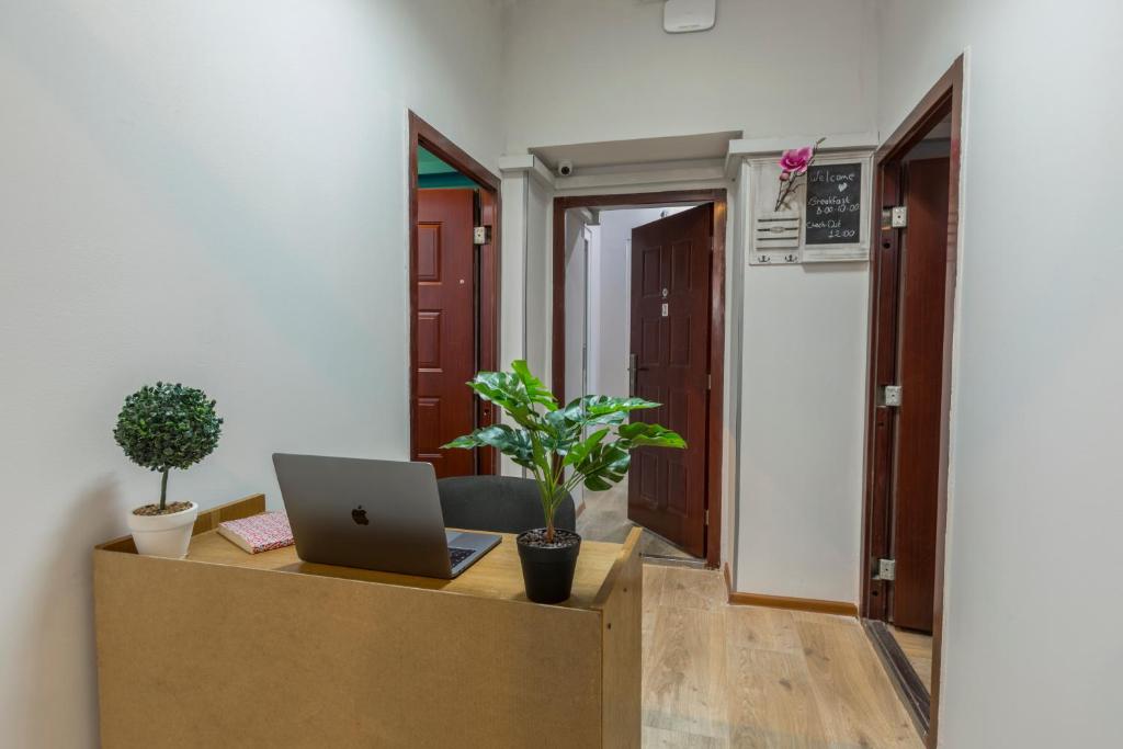 an office with a desk with a laptop on it at GLOBAL HOSTEL - Freedom Square in Tbilisi City