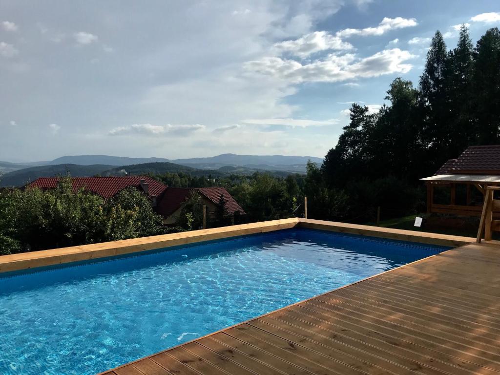 a swimming pool with a view of the mountains at Pensjonat Zacisze in Czchów