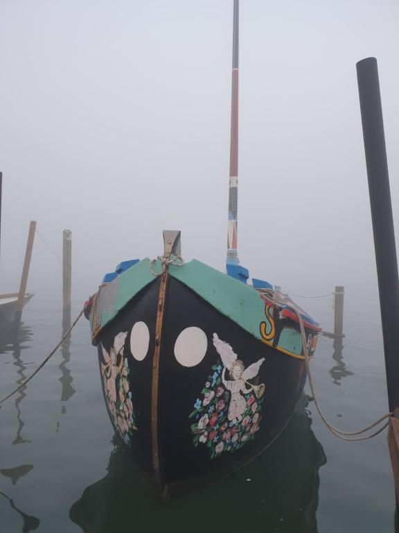 a boat with a painting on it sitting in the water at Casa Mafalda in Chioggia