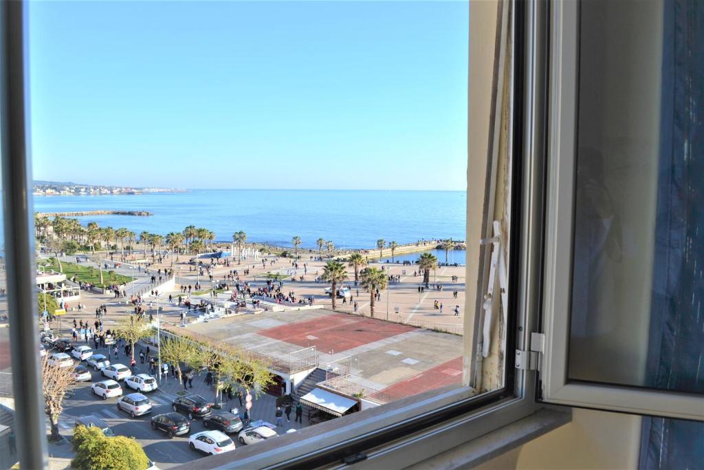 a view of the beach from a window of a building at B&B VistaMare in Civitavecchia