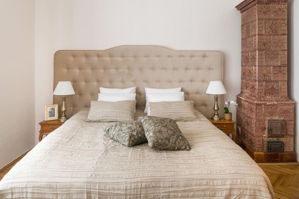a bedroom with a large bed with two pillows on it at Belle Epoque II, luxury suite 50m to Main Square in Krakow