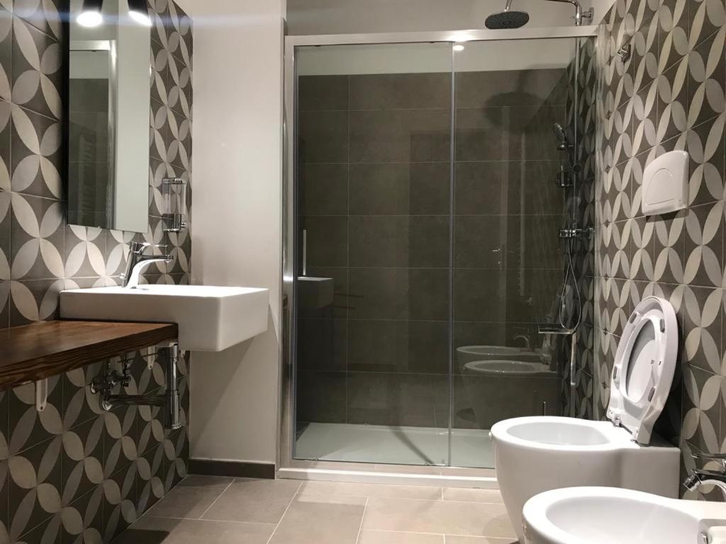 a bathroom with a shower and a toilet and a sink at AREA 19 in Catanzaro