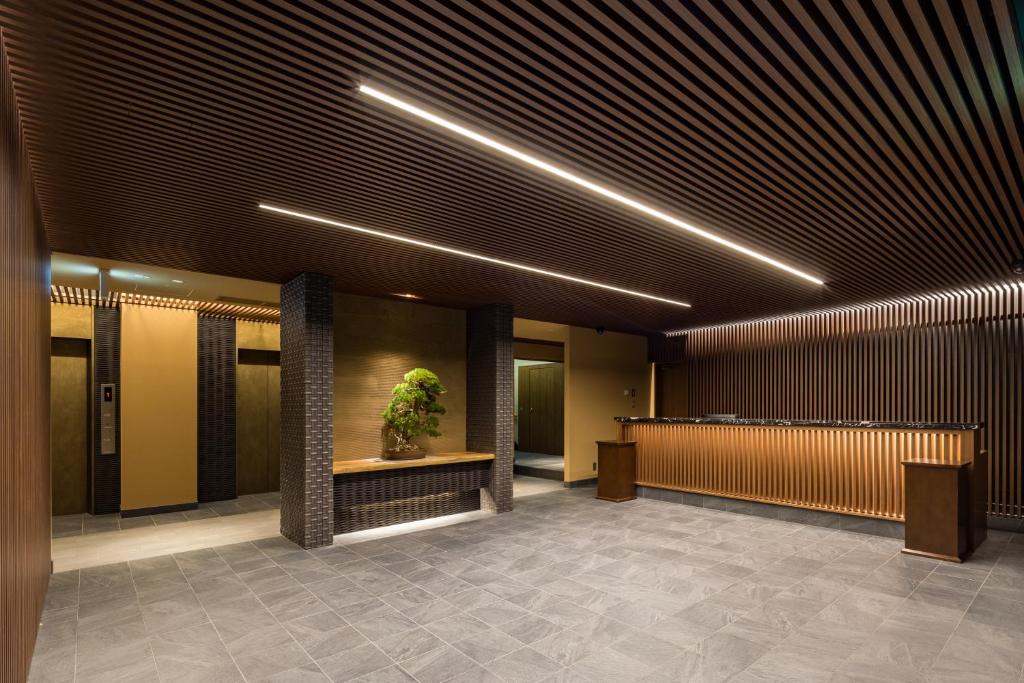 a lobby with a potted plant in a building at Oike Hotel in Fujikawaguchiko
