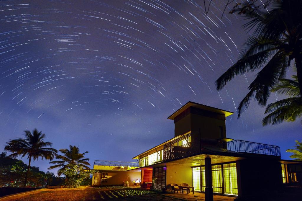 a house with star trails in the sky at Homestay Namaha in Meppādi