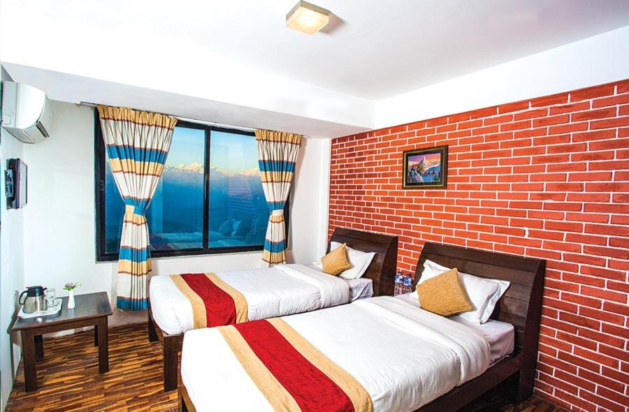 Postel nebo postele na pokoji v ubytování Hotel Himalayan Villa