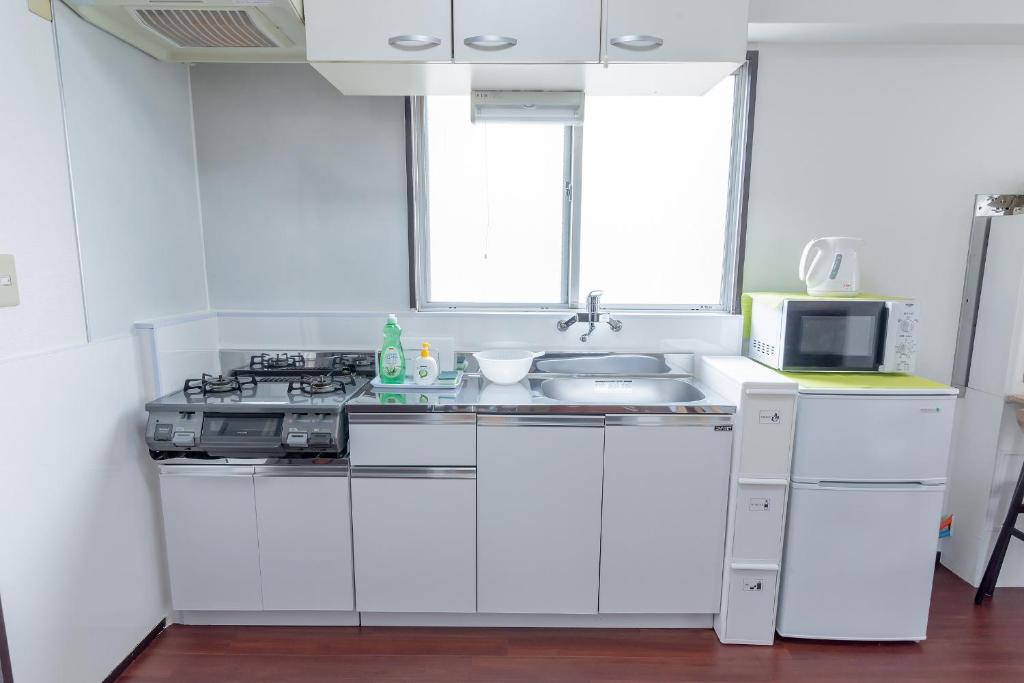 Kuchyň nebo kuchyňský kout v ubytování Uhome Iriya Apartment