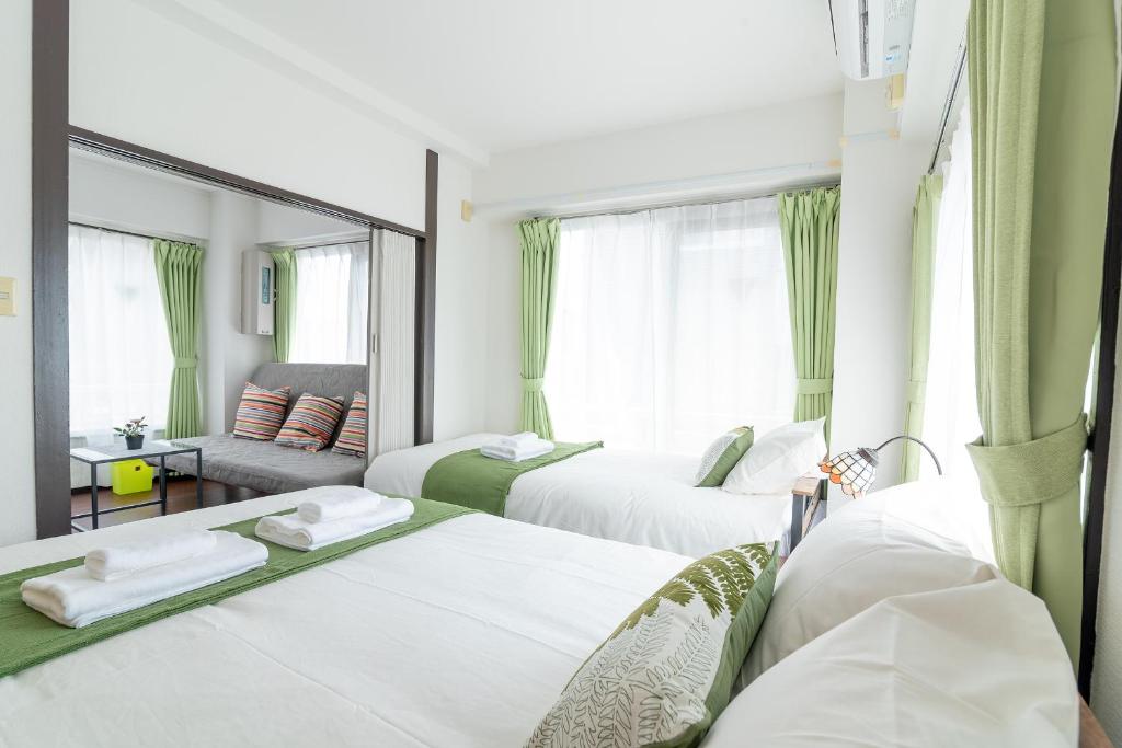 Postel nebo postele na pokoji v ubytování Uhome Iriya Apartment