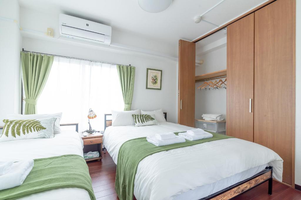 Postel nebo postele na pokoji v ubytování Uhome Iriya Apartment