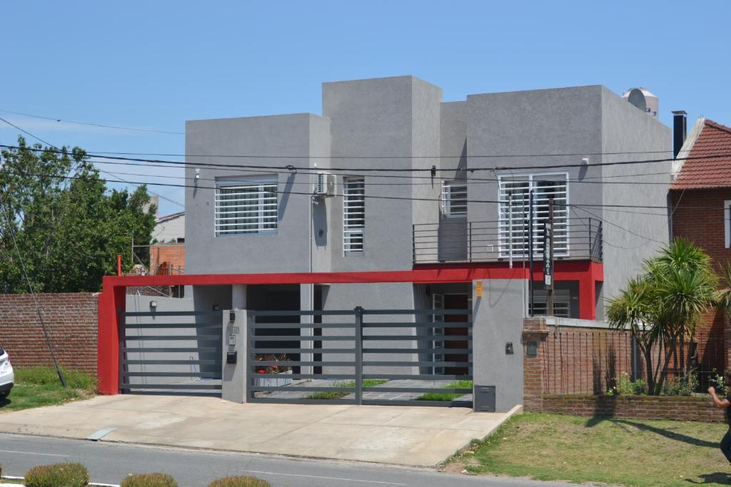 a building with a red trim on a street at Don Ramon Departamentos Premium in Tandil