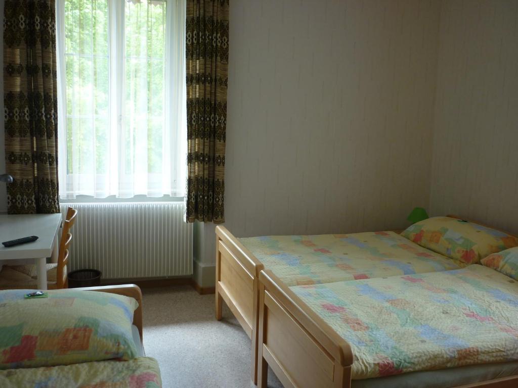 Postel nebo postele na pokoji v ubytování La Caquerelle