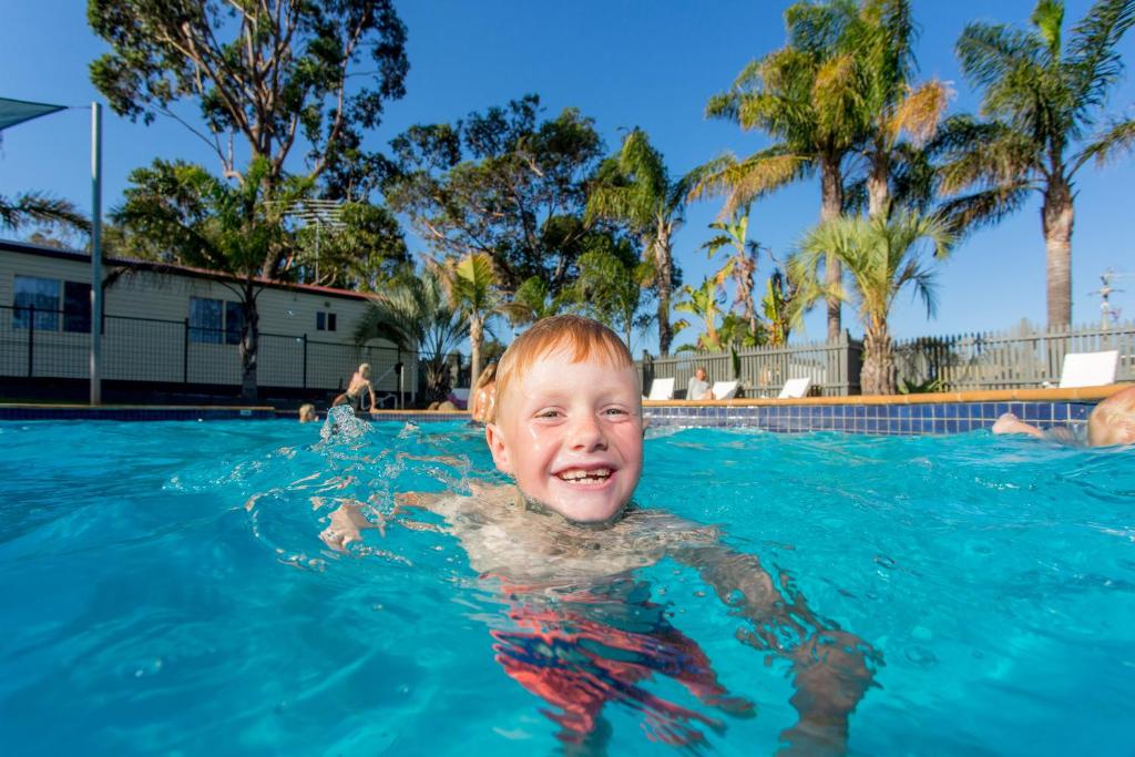 a young boy swimming in a swimming pool at Ingenia Holidays Torquay Australia in Torquay