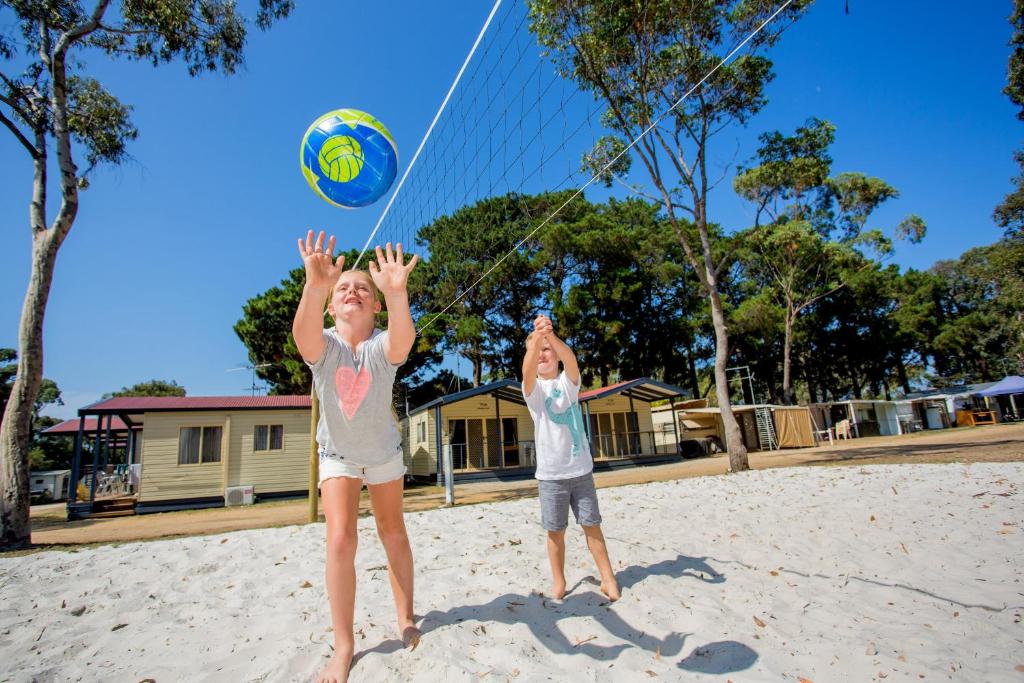 two children playing with a volley ball on the beach at Ingenia Holidays Torquay Australia in Torquay