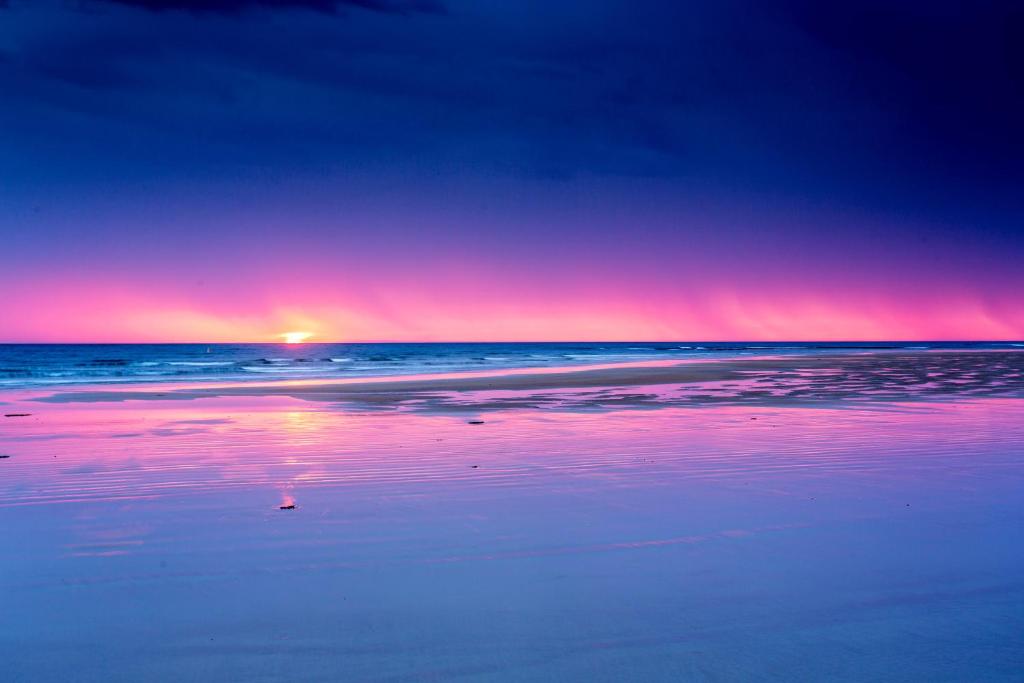 a sunset on a beach with the ocean at Ingenia Holidays Torquay Australia in Torquay