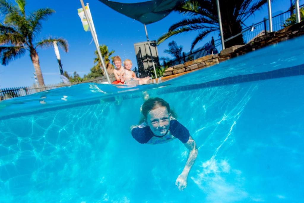 a boy in the water in a swimming pool at Ingenia Holidays Torquay Australia in Torquay
