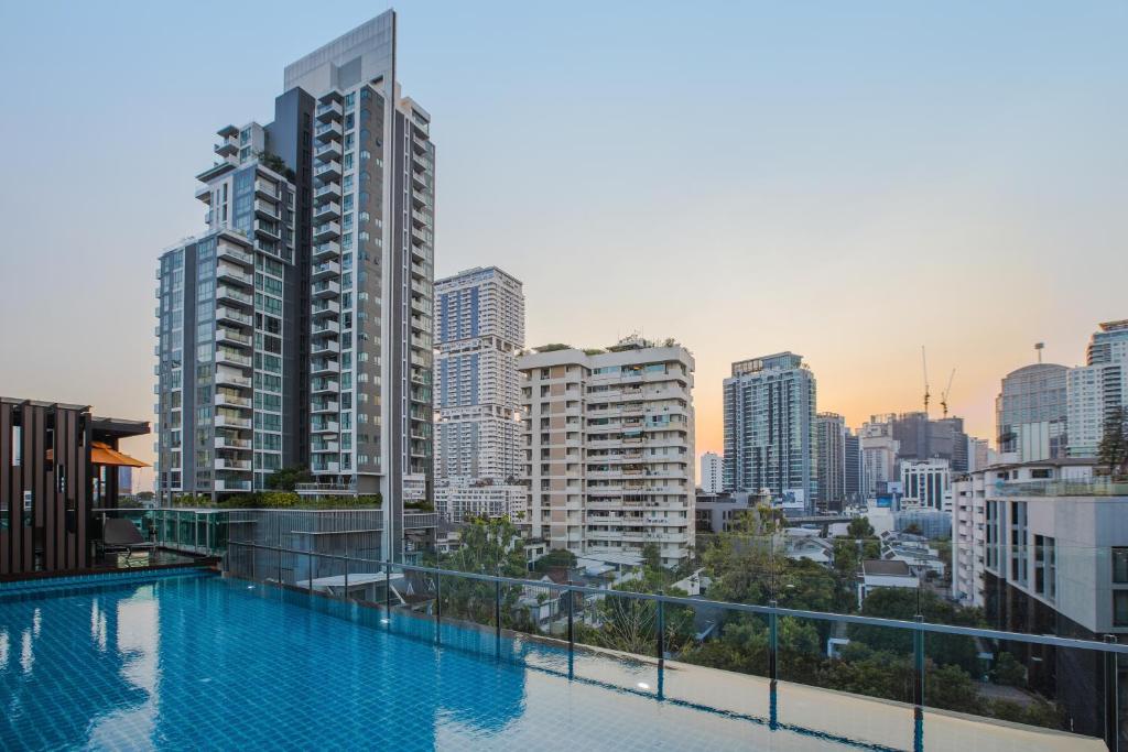 A rooftop pool looking across Bangkok’s high-rise skyline.