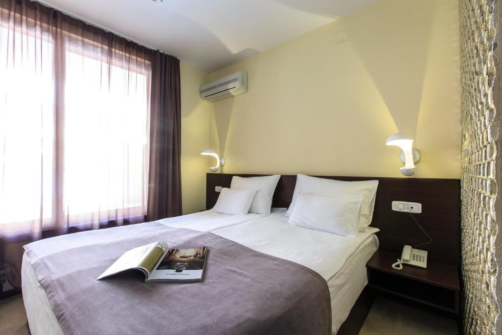 Postel nebo postele na pokoji v ubytování Hotel Premier