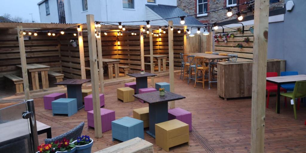 a patio with tables and chairs in a restaurant at Barley Sheaf, Old Bridge Street EN SUITE ROOMS, ROOM ONLY in Truro