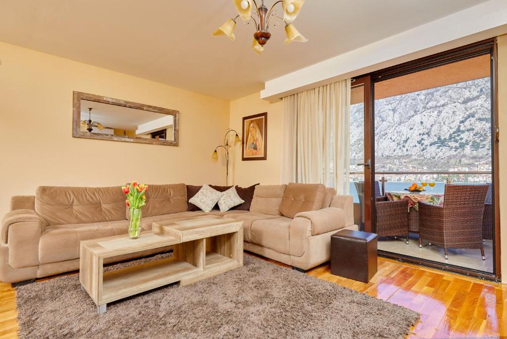 a living room with a couch and a table at Blanka Sea View Apartments in Kotor