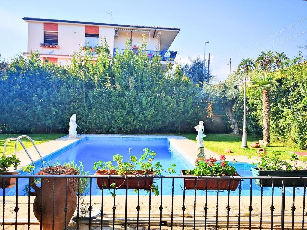 a swimming pool with potted plants on a fence at Villa Rosyiano in Misterbianco