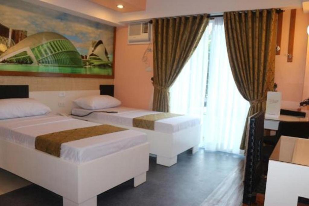 Postel nebo postele na pokoji v ubytování Eurotel Boracay