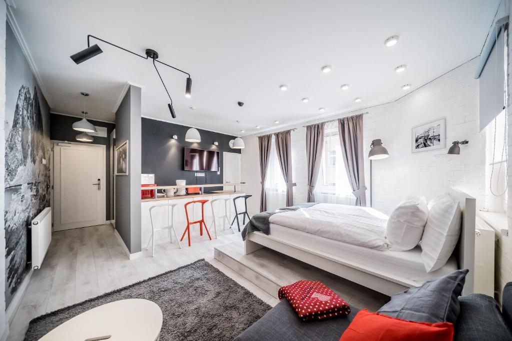 a bedroom with a large bed and a kitchen at Revelton Studios Karlovy Vary in Karlovy Vary
