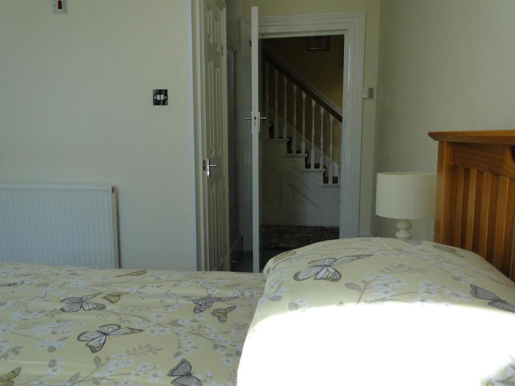 Postel nebo postele na pokoji v ubytování Rockleaze Guesthouse