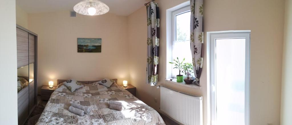 Posteľ alebo postele v izbe v ubytovaní Alicja Apartament